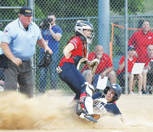 
			
				                                Abington Heights’ Marley Sarafinko slides underneath Patriots catcher Ava Callahan before the throw to the plate to score the first run of Tuesday night’s district title game at Wilkes.
                                 Tony Callaio | For Times Leader

			
		