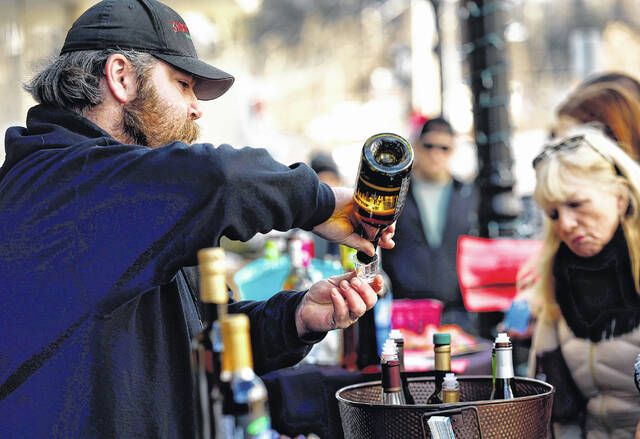 <p>TimWells pours a sample of his product at the Deep Roots Hard Cider stand on Depot Street during the Clarks Summit Festival of Ice on Saturday, Jan. 28.</p>
                                 <p>Fred Adams | For Abington Journal</p>