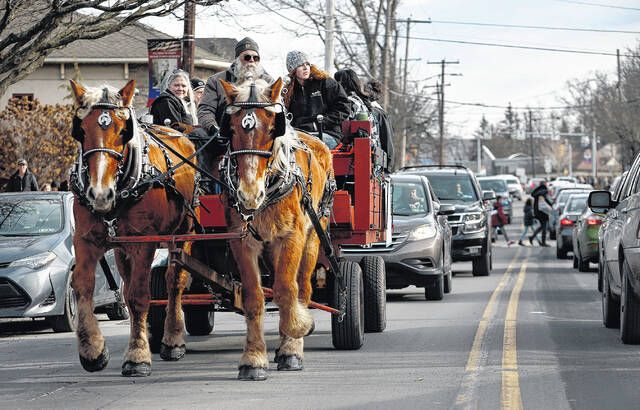 <p>The horse drawn wagon ride goes down State Street with traffic following behind during the Clarks Summit Festival of Ice on Saturday, Jan. 28.</p>
                                 <p>Fred Adams | For Abington Journal</p>